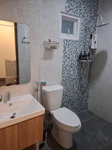 a bathroom with a toilet and a sink at 365Poolvilla Songkhla in Ban Laem Takhian