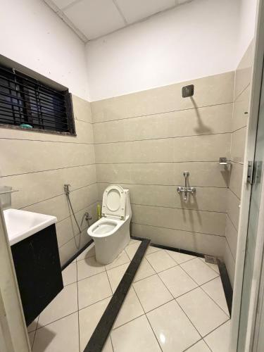 a bathroom with a toilet and a sink at Triple A Gardens in Kollam