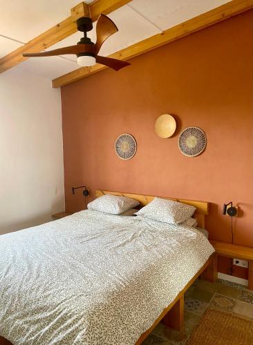 a bedroom with a bed and a ceiling fan at Casa Gaïa in Borge