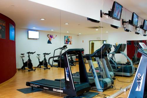 a gym with treadmills and exercise bikes in a room at Grand Muthu Forte do Vale in Albufeira