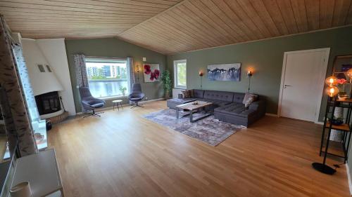 a living room with a couch and a table at Prestelandet Guesthouse in Fredrikstad