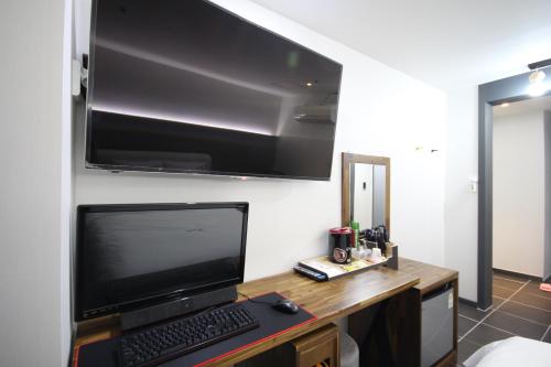 a desk with a laptop computer on top of it at Hotel Don in Changwon