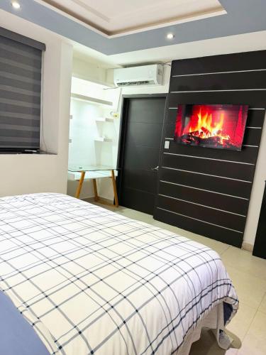 a bedroom with a bed and a fireplace at Depa YAZI in Villahermosa