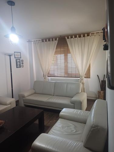 a living room with a couch and a window at SsaZza in Râmnicu Vâlcea