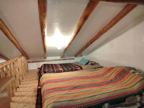 a bedroom with a bed in a attic at Sami Huaypo Cabin in Cheqquerec