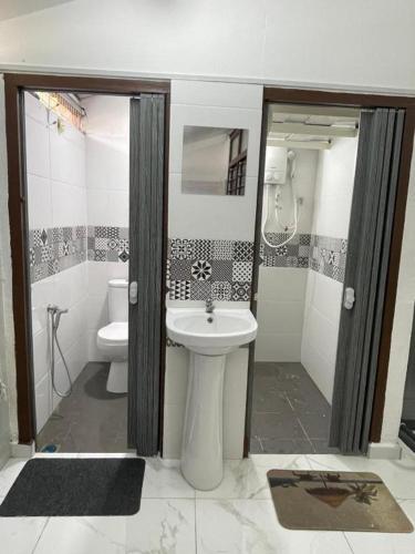 a bathroom with a sink and a toilet at SELAMA Merdeka Homestay 2-6pax in Selama
