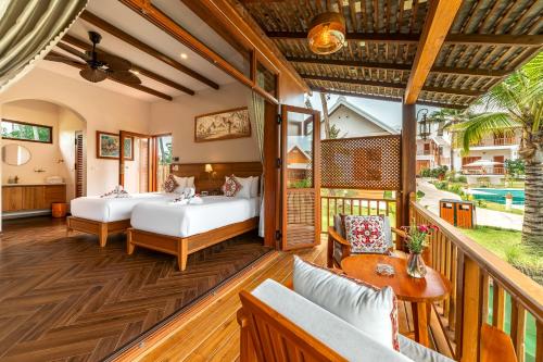 a balcony with two beds and a table at The Jam Boutique Hotel in Luang Prabang