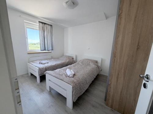 a small room with a bed and a window at Apartment Doris in Tomislavgrad