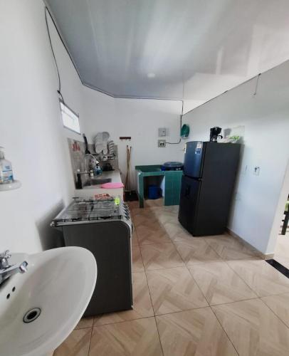 a kitchen with a sink and a refrigerator at Apt vacacional 301 in Doradal