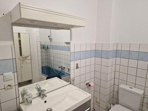 a white bathroom with a sink and a toilet at Appartement 45m2 à Florange in Florange