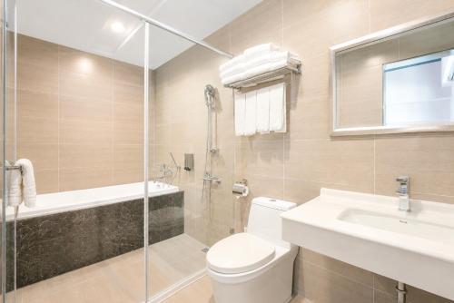 a bathroom with a toilet and a sink and a shower at Mo in Houli