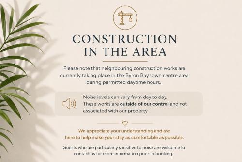a sign for construction in the area with a plant at Byron Quarter Apartments in Byron Bay