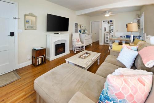 a living room with a couch and a fireplace at Charming Beach Bungalow in Seal Beach