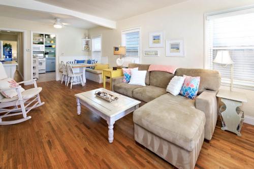 a living room with a couch and a table at Charming Beach Bungalow in Seal Beach