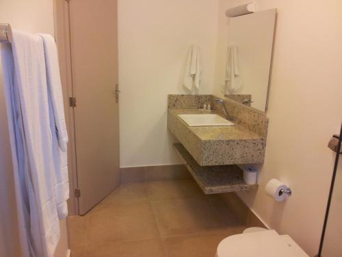 a bathroom with a sink and a mirror at Kaakupe Praia Hotel in Guaratuba