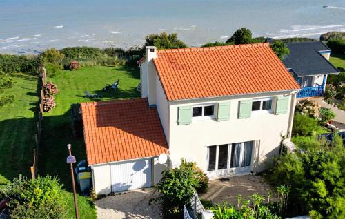 an aerial view of a white house with an orange roof at Maison Vue Mer in Quiberville