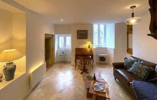 a living room with a couch and a table at Belle Maison À Colombages in La Baroche-sous-Lucé