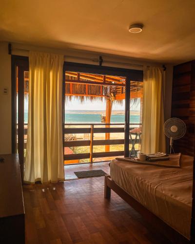 a bedroom with a bed and a view of the ocean at Casa Lobos in Lobitos