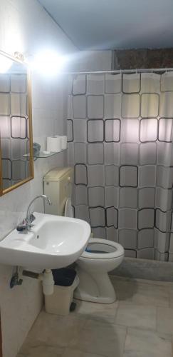 a bathroom with a white toilet and a sink at Eco wellness the arch in Lévktron