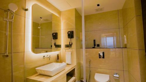 a bathroom with a sink and a shower at Palette Hill View Resorts Vagamon in Vagamon