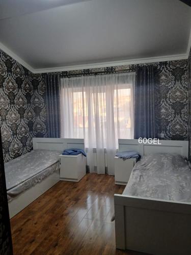 a bedroom with two twin beds and a window at Tyom in Khodzhabegi