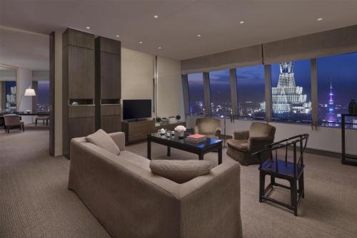 a living room with a couch and a table at Park Hyatt Shanghai in Shanghai