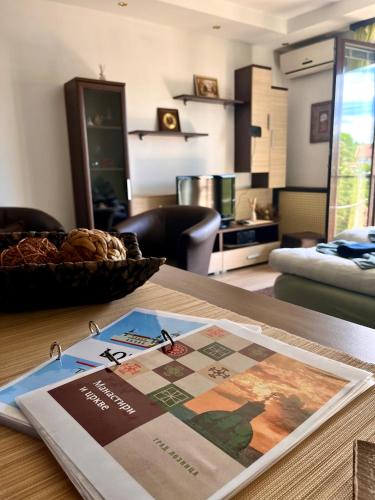a table with a magazine on top of a room at EukaVita in Banja Koviljača