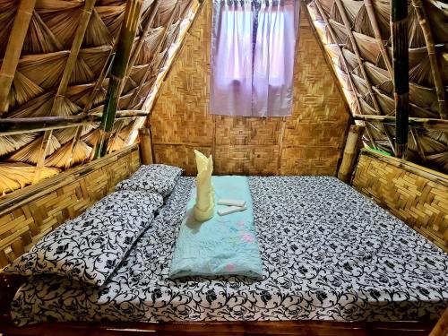 a small room with a bed in a tent at Itawis Resort - Nature Chalet in Silang