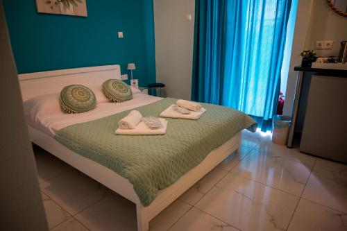 a bedroom with a bed with towels on it at MANI HOLIDAYS Rooms in Neo Itilo