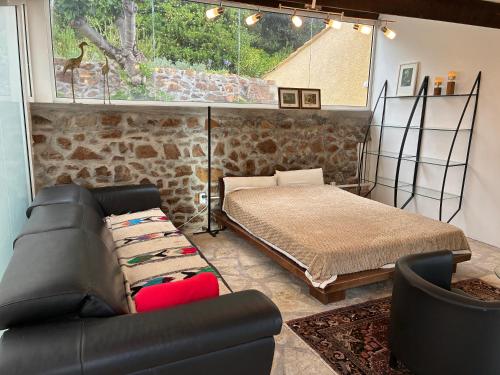 a living room with a bed and a couch at Villa Naussica in Saint-Raphaël