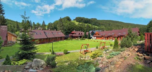 a resort with a large yard with a playground at Dolina Leśnicy SKI & SPA Resort in Brenna