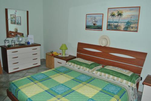 a bedroom with a bed and a dresser at Casa Salina in Torre Colimena