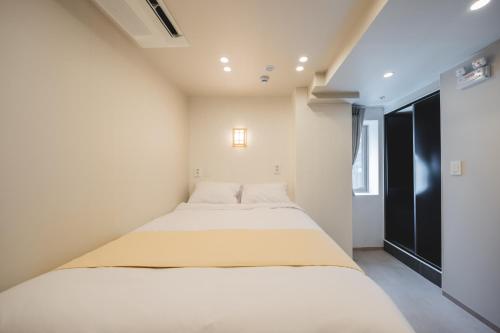 a small bedroom with two beds in it at Seoul101 Jongno in Seoul