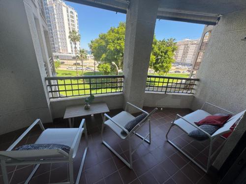 a balcony with chairs and a table with a view at Pueblo Español in Cullera