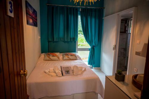 a bedroom with a bed with a book on it at MANI HOLIDAYS Rooms in Neo Itilo
