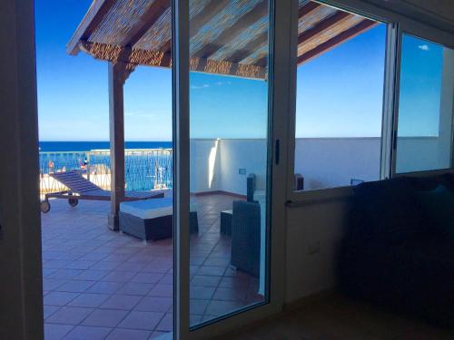 a view of a balcony with a view of the ocean at Solarium Achilles in Giardini Naxos