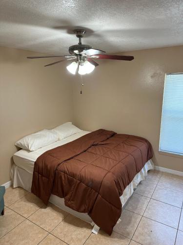 a bedroom with a bed and a ceiling fan at A cozy room with double bed in semi shared Flat in Wallisellen