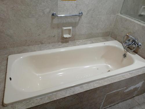 a white bath tub in a bathroom at Imperial resident time Square KL in Kuala Lumpur