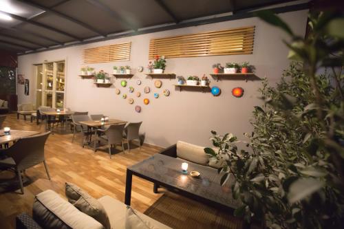 a living room with a couch and tables and chairs at North Point Hotel in Denizli