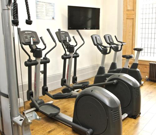 a row of exercise bikes in a gym at Sandeman-Allen Hostel (Bayswater) in London