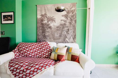 a living room with a white couch and green walls at 2 ch, climatisé, parking, localisation premium in Lyon