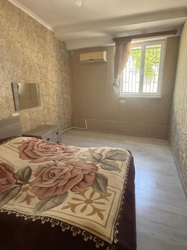 a bedroom with a bed with a blanket on it at Full moon in Yerevan