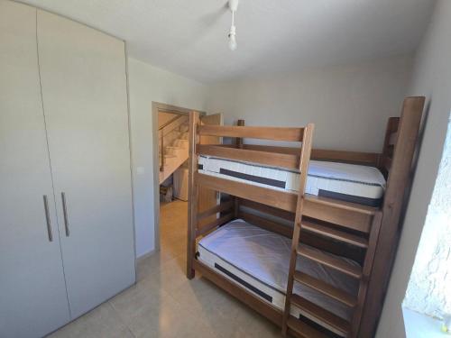 a room with two bunk beds and a closet at Vlad's Apartments in Larisa