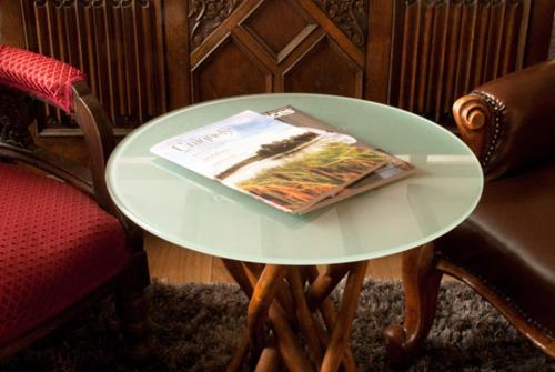 a white table with a book on it next to a chair at Swan House in Beccles