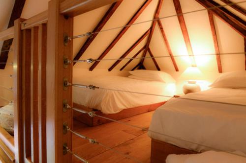 a bedroom with two beds in a room at Swan House in Beccles