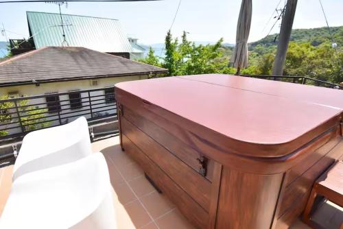 a wooden tub sitting on top of a balcony at Sunrise Resort Aji in Takamatsu