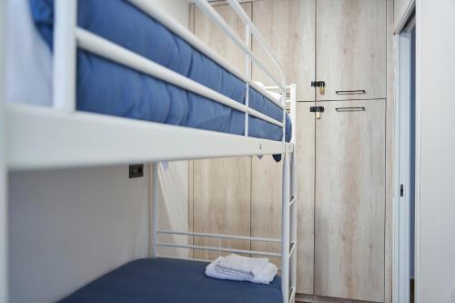a bunk bed with a blue mattress in a room at The Clock Tower Apartment in Jaén