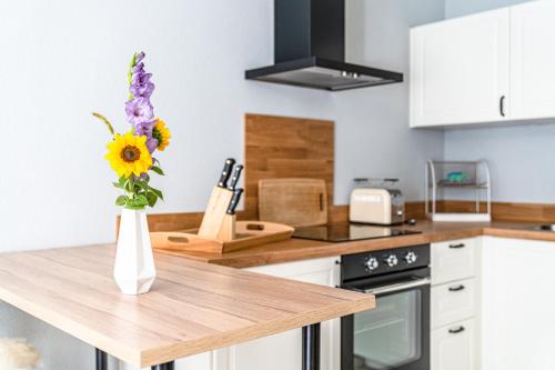 a kitchen with a vase of flowers on a counter at stuub langenbach in Titisee-Neustadt
