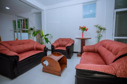 a living room with two couches and a table at LHK Dream Resort Matara in Palatuwa