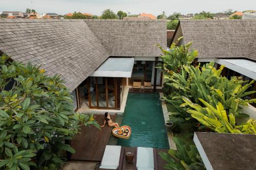 an aerial view of a house with a swimming pool at Sanora Villa Sanur by Ini Vie Hospitality in Sanur